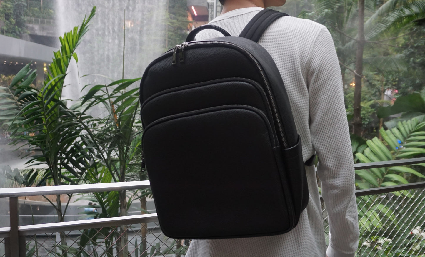 Unisex cowhide leather backpack Crescent design with luggage/trolley sleeve