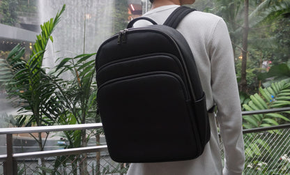 Unisex cowhide leather backpack Crescent design with luggage/trolley sleeve
