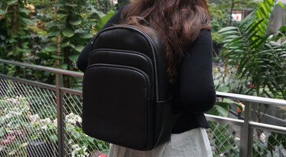 Unisex cowhide leather backpack Crescent design with luggage/trolley sleeve
